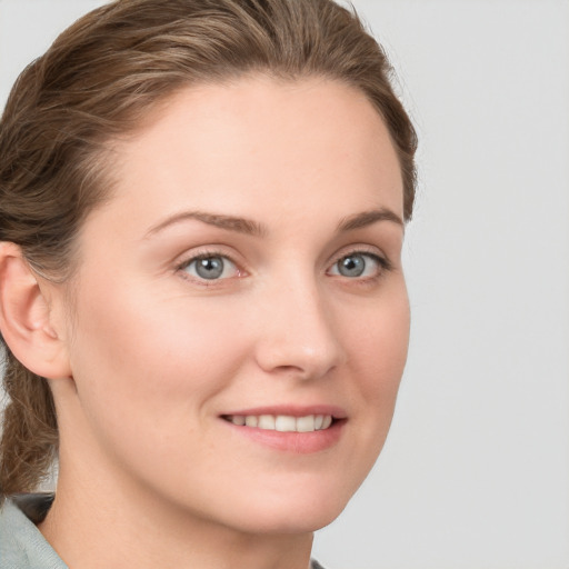 Joyful white young-adult female with long  brown hair and blue eyes