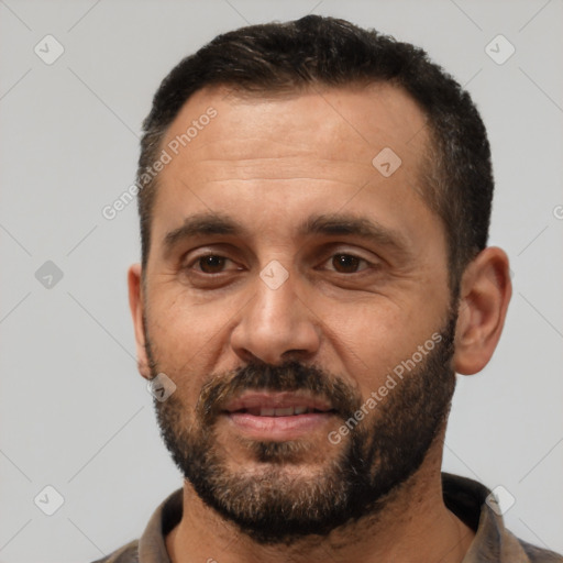 Joyful white adult male with short  black hair and brown eyes