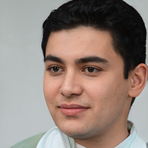 Joyful white young-adult male with short  black hair and brown eyes