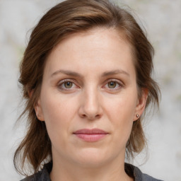 Joyful white young-adult female with medium  brown hair and blue eyes