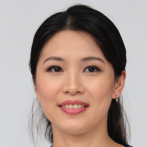 Joyful asian young-adult female with medium  black hair and brown eyes