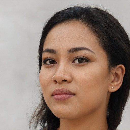 Neutral latino young-adult female with long  black hair and brown eyes