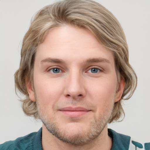 Joyful white young-adult male with medium  brown hair and blue eyes