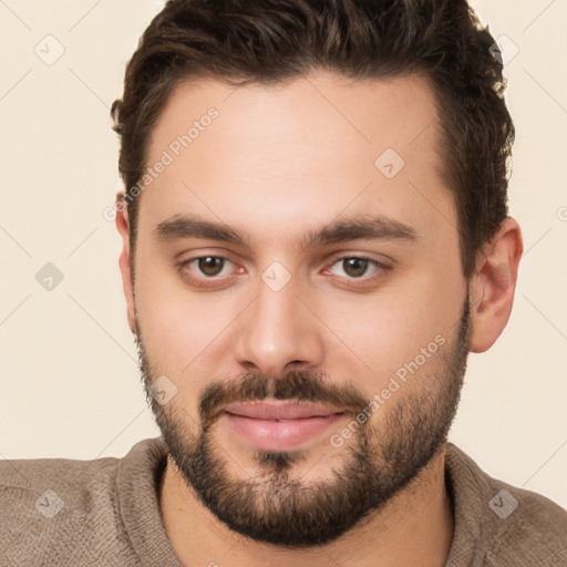 Joyful white young-adult male with short  brown hair and brown eyes