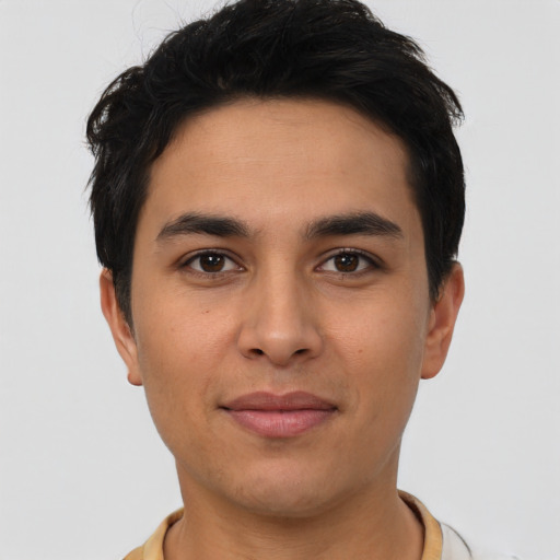 Joyful latino young-adult male with short  black hair and brown eyes