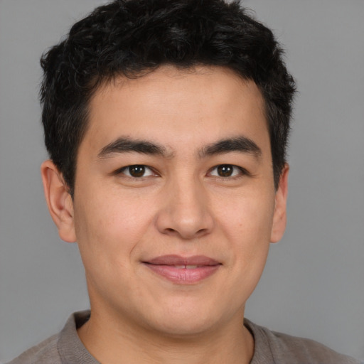 Joyful latino young-adult male with short  brown hair and brown eyes