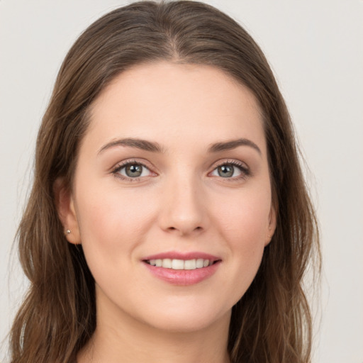 Joyful white young-adult female with long  brown hair and grey eyes