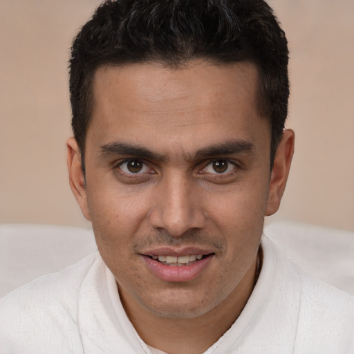 Joyful white young-adult male with short  brown hair and brown eyes