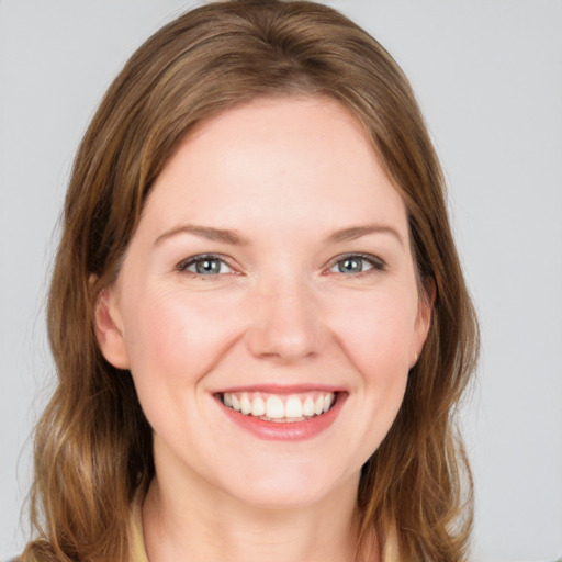 Joyful white young-adult female with medium  brown hair and grey eyes