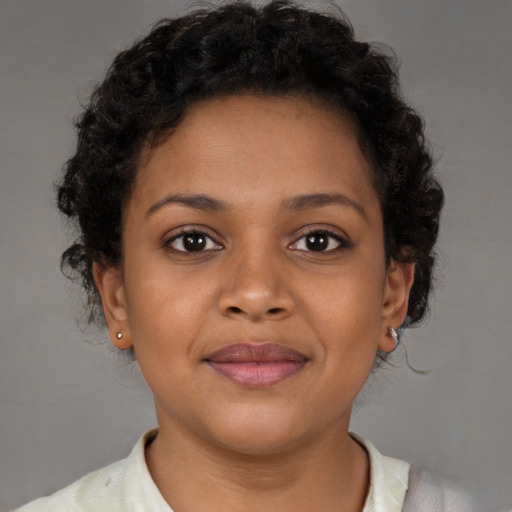Joyful black young-adult female with short  brown hair and brown eyes