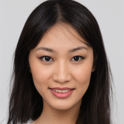 Joyful asian young-adult female with long  brown hair and brown eyes