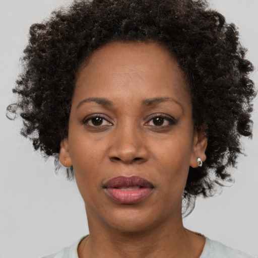 Joyful black adult female with short  brown hair and brown eyes