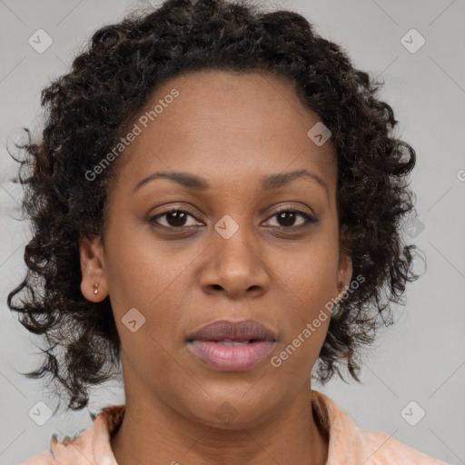 Joyful black adult female with medium  brown hair and brown eyes