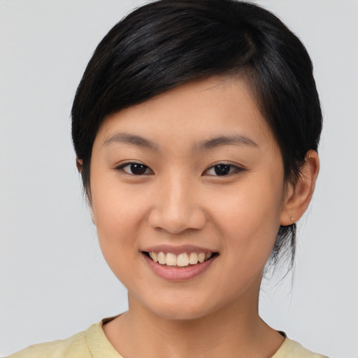 Joyful asian young-adult female with medium  black hair and brown eyes