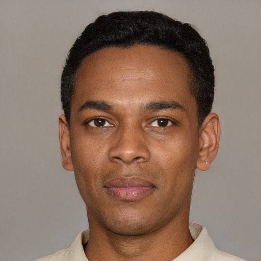 Joyful black young-adult male with short  black hair and brown eyes
