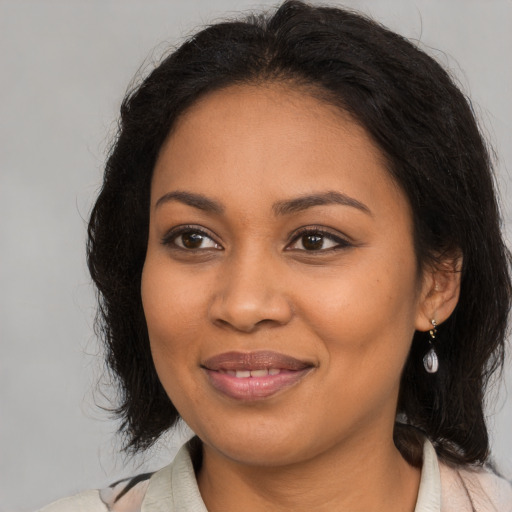 Joyful black young-adult female with medium  brown hair and brown eyes