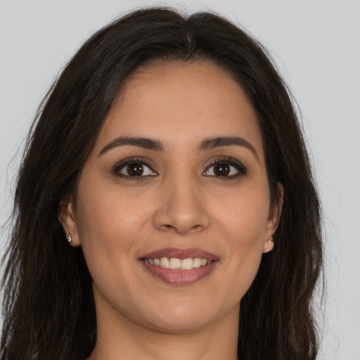 Joyful white young-adult female with long  brown hair and brown eyes