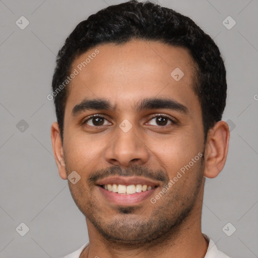 Joyful latino young-adult male with short  black hair and brown eyes