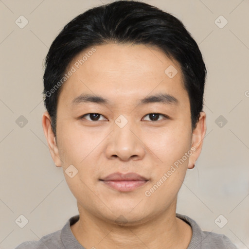 Joyful asian young-adult male with short  black hair and brown eyes