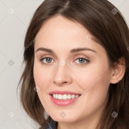 Joyful white young-adult female with long  brown hair and green eyes