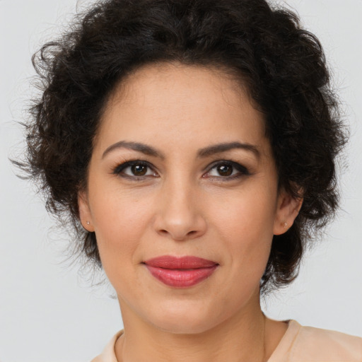 Joyful latino adult female with long  brown hair and brown eyes