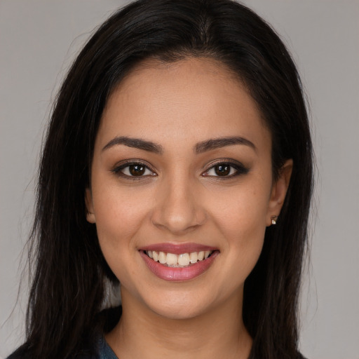 Joyful white young-adult female with long  brown hair and brown eyes