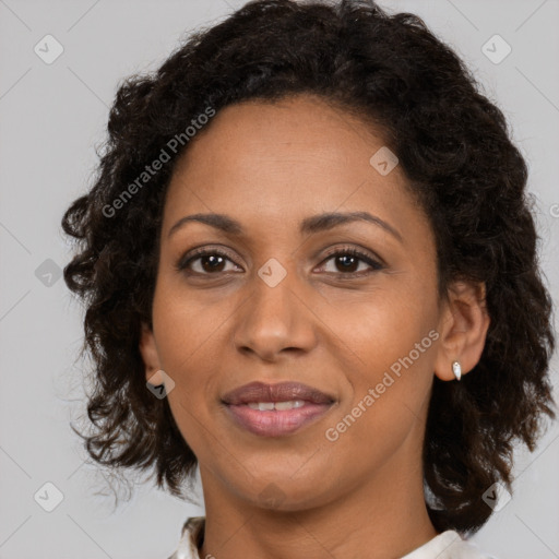 Joyful black adult female with medium  brown hair and brown eyes