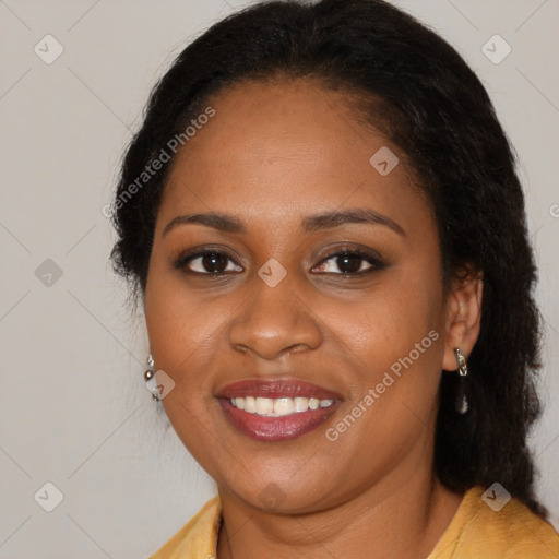 Joyful black young-adult female with long  brown hair and brown eyes