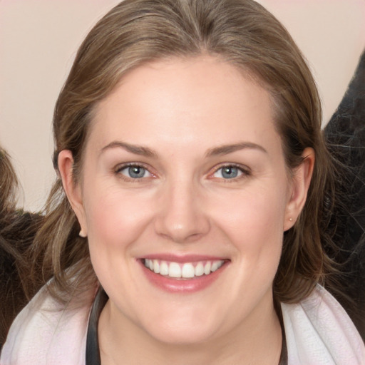 Joyful white young-adult female with medium  brown hair and grey eyes