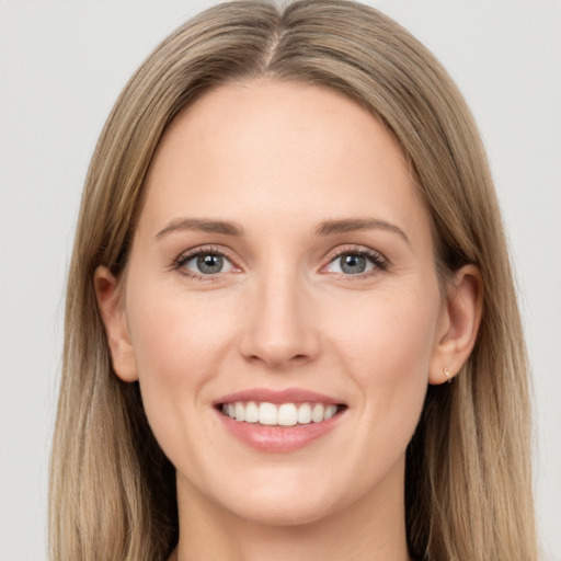 Joyful white young-adult female with long  brown hair and grey eyes