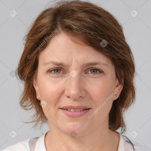 Joyful white adult female with medium  brown hair and grey eyes