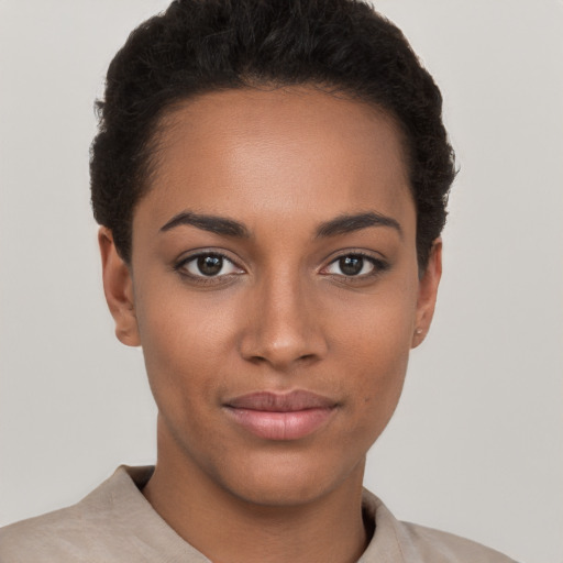 Joyful black young-adult female with short  brown hair and brown eyes