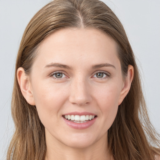 Joyful white young-adult female with long  brown hair and grey eyes