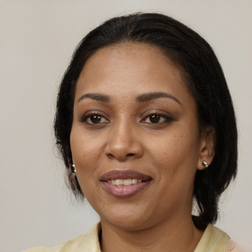 Joyful black young-adult female with medium  black hair and brown eyes