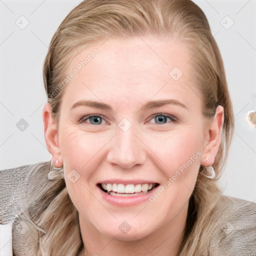 Joyful white young-adult female with long  brown hair and blue eyes