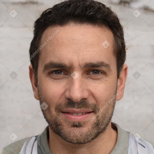 Joyful white adult male with short  brown hair and brown eyes