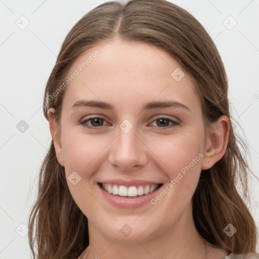 Joyful white young-adult female with long  brown hair and grey eyes