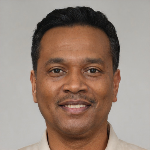 Joyful latino adult male with short  black hair and brown eyes