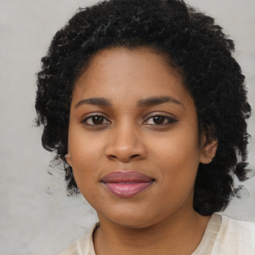 Joyful black young-adult female with medium  black hair and brown eyes