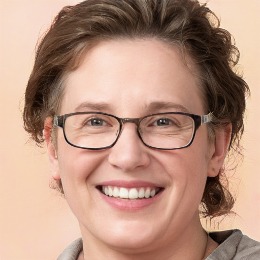 Joyful white adult female with medium  brown hair and blue eyes