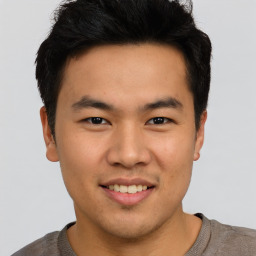 Joyful asian young-adult male with short  brown hair and brown eyes