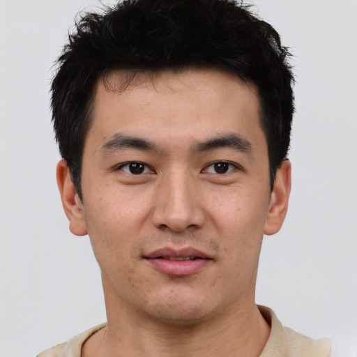 Joyful asian young-adult male with short  black hair and brown eyes