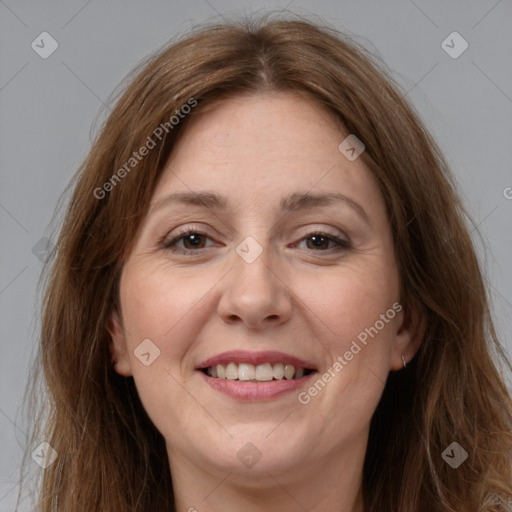 Joyful white adult female with long  brown hair and brown eyes