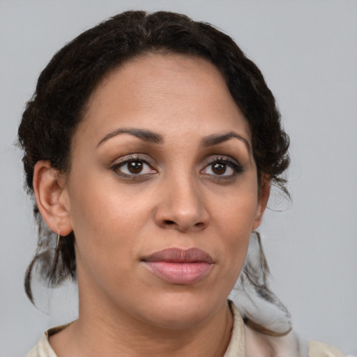 Joyful latino young-adult female with medium  brown hair and brown eyes