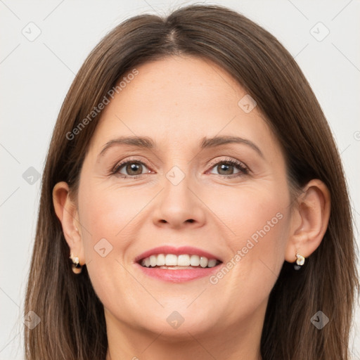 Joyful white adult female with long  brown hair and grey eyes