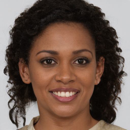 Joyful black young-adult female with medium  brown hair and brown eyes