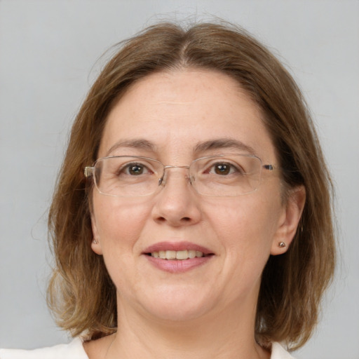 Joyful white adult female with medium  brown hair and green eyes