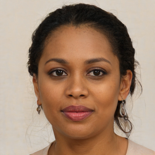Joyful black young-adult female with short  brown hair and brown eyes
