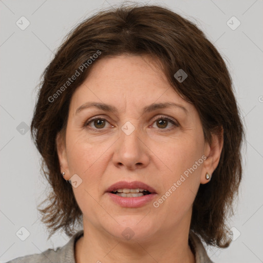 Joyful white adult female with medium  brown hair and grey eyes