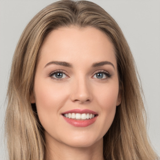 Joyful white young-adult female with long  brown hair and brown eyes